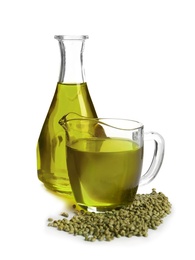 Photo of Glassware with hemp oil and seeds on white background