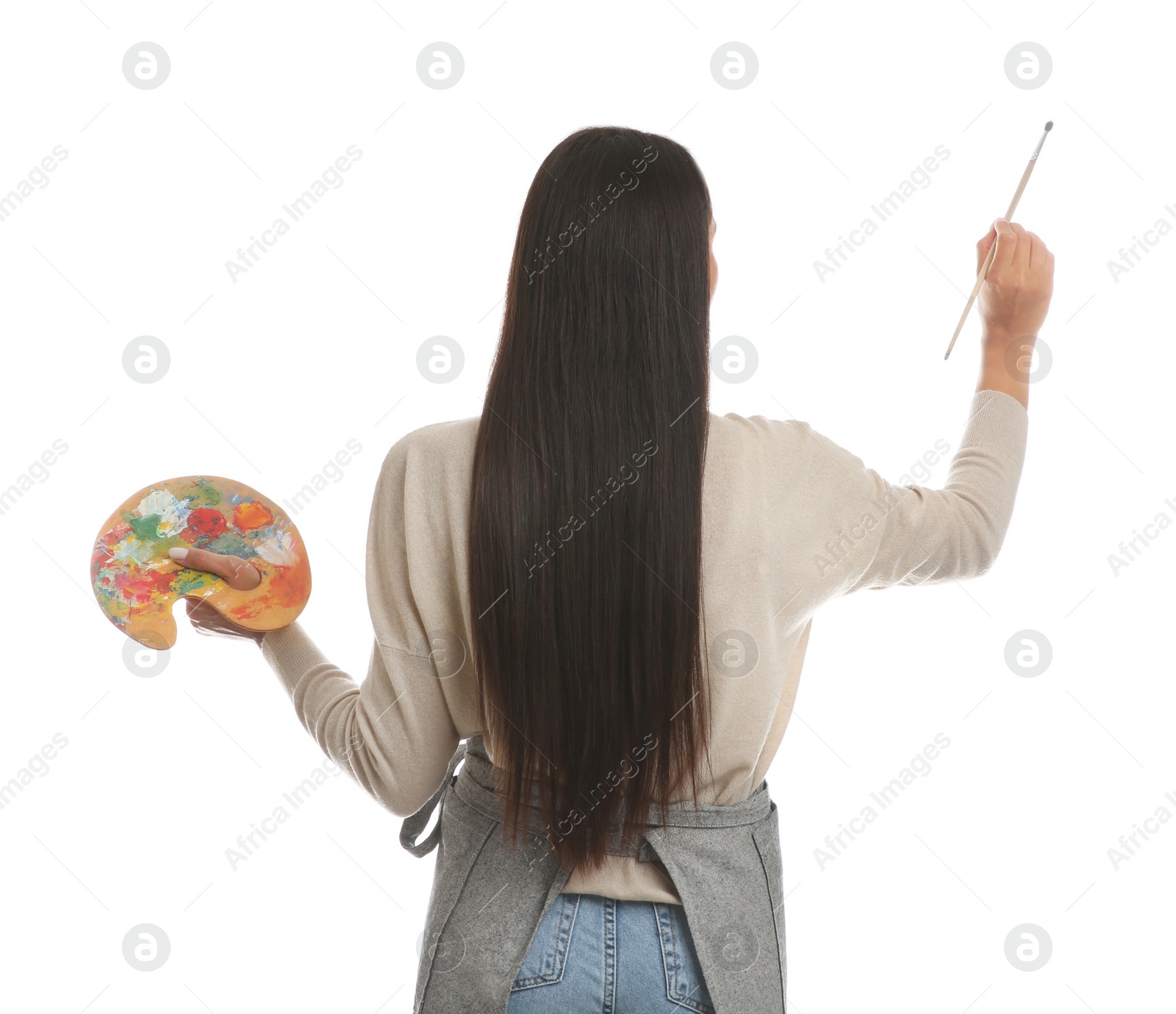 Photo of Young woman drawing with brush on white background, back view