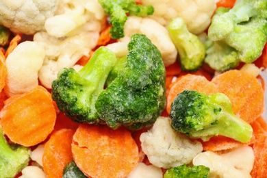 Frozen vegetable mix as background, closeup view