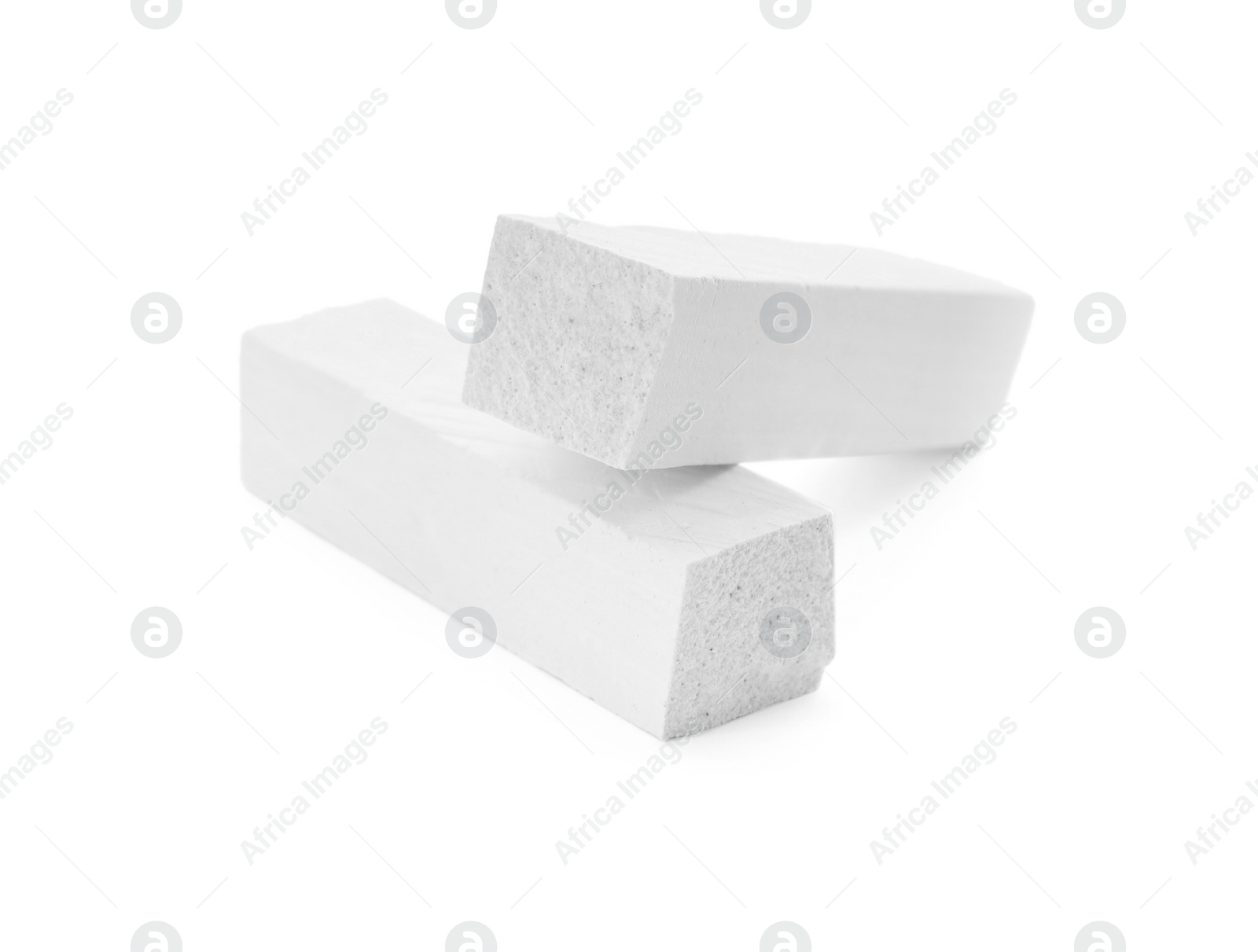 Photo of Small pieces of chalk on white background