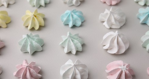 Photo of Delicious meringue cookies on light background, above view