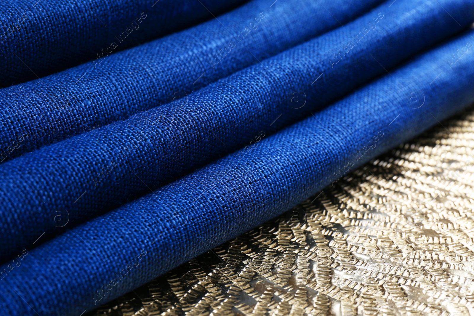 Photo of Blue kitchen napkins on textured background, closeup