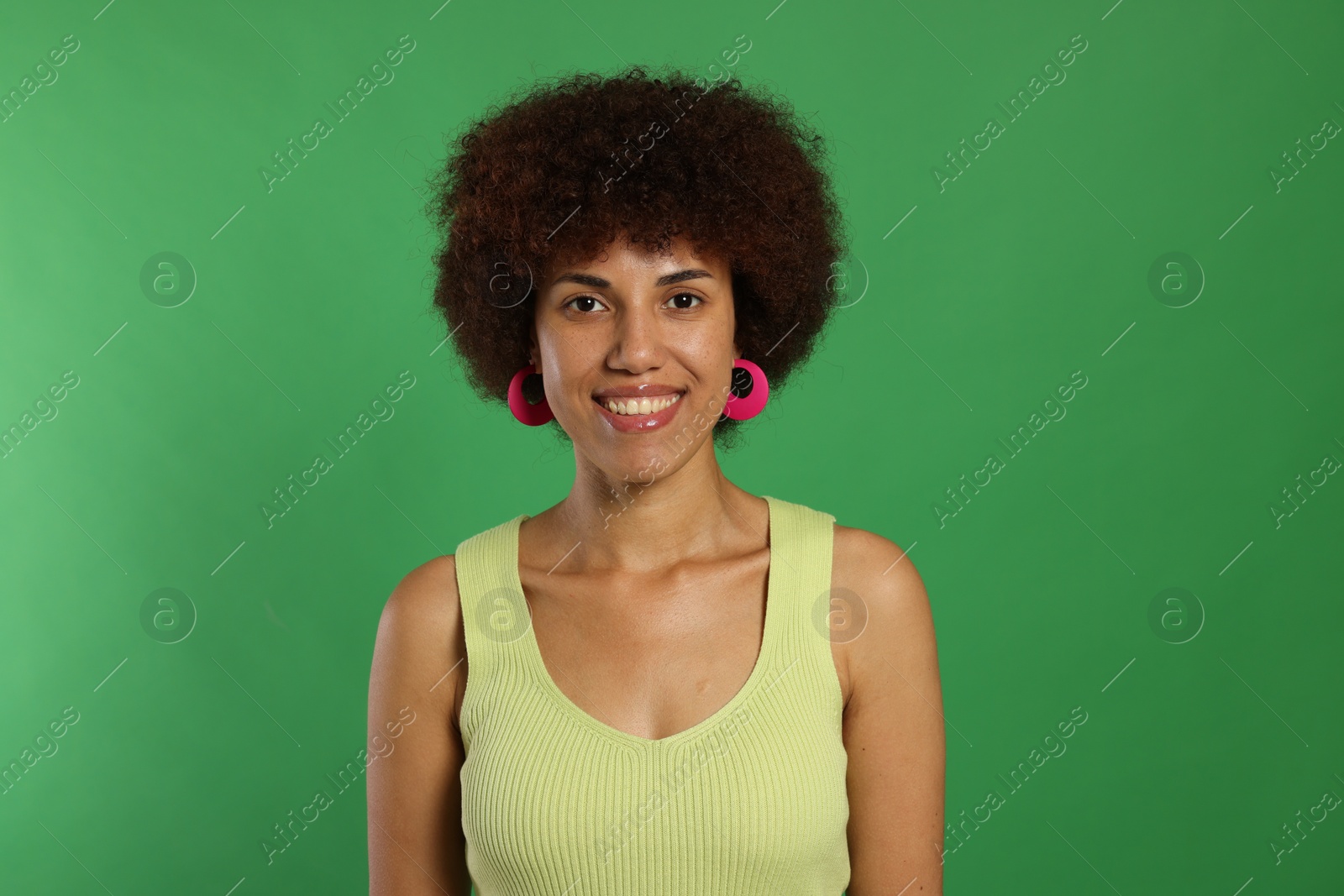 Photo of Portrait of happy young woman on green background