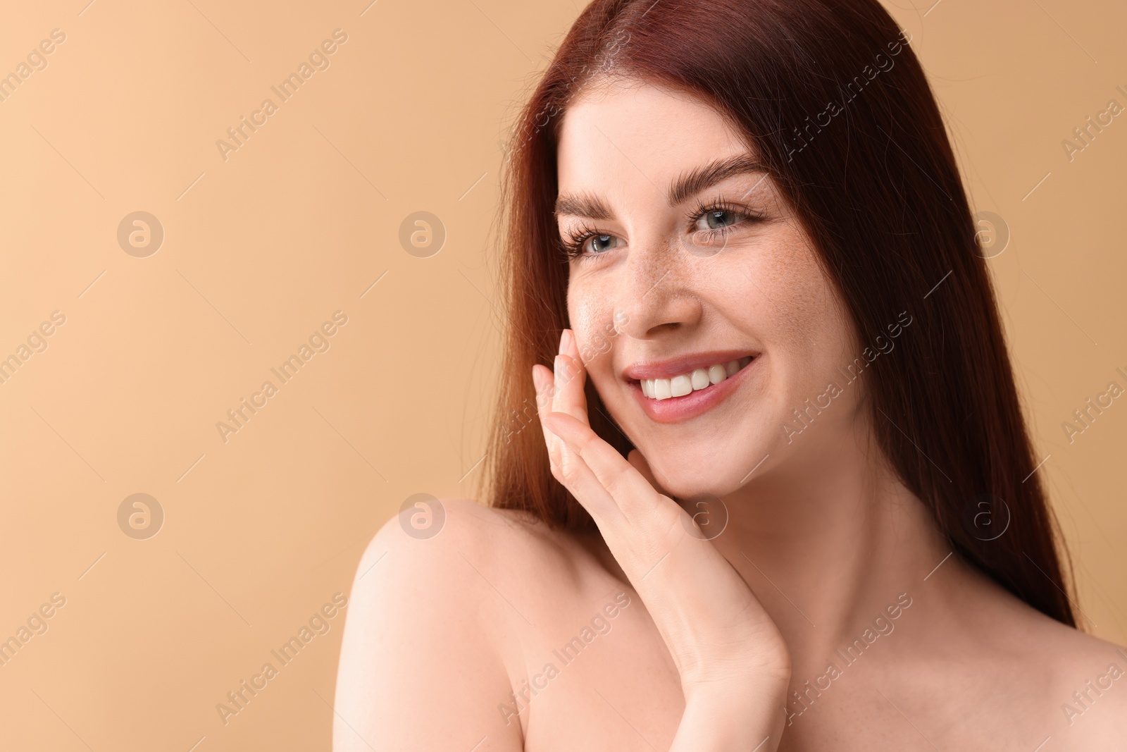 Photo of Portrait of smiling woman on beige background, closeup. Space for text