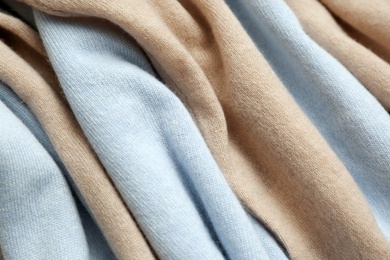 Photo of Different cashmere clothes as background, closeup view