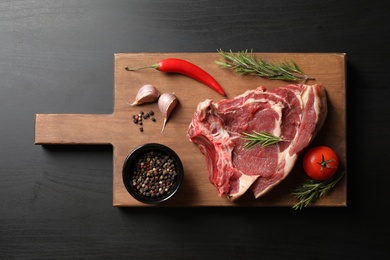 Photo of Composition with fresh meat on black table, top view