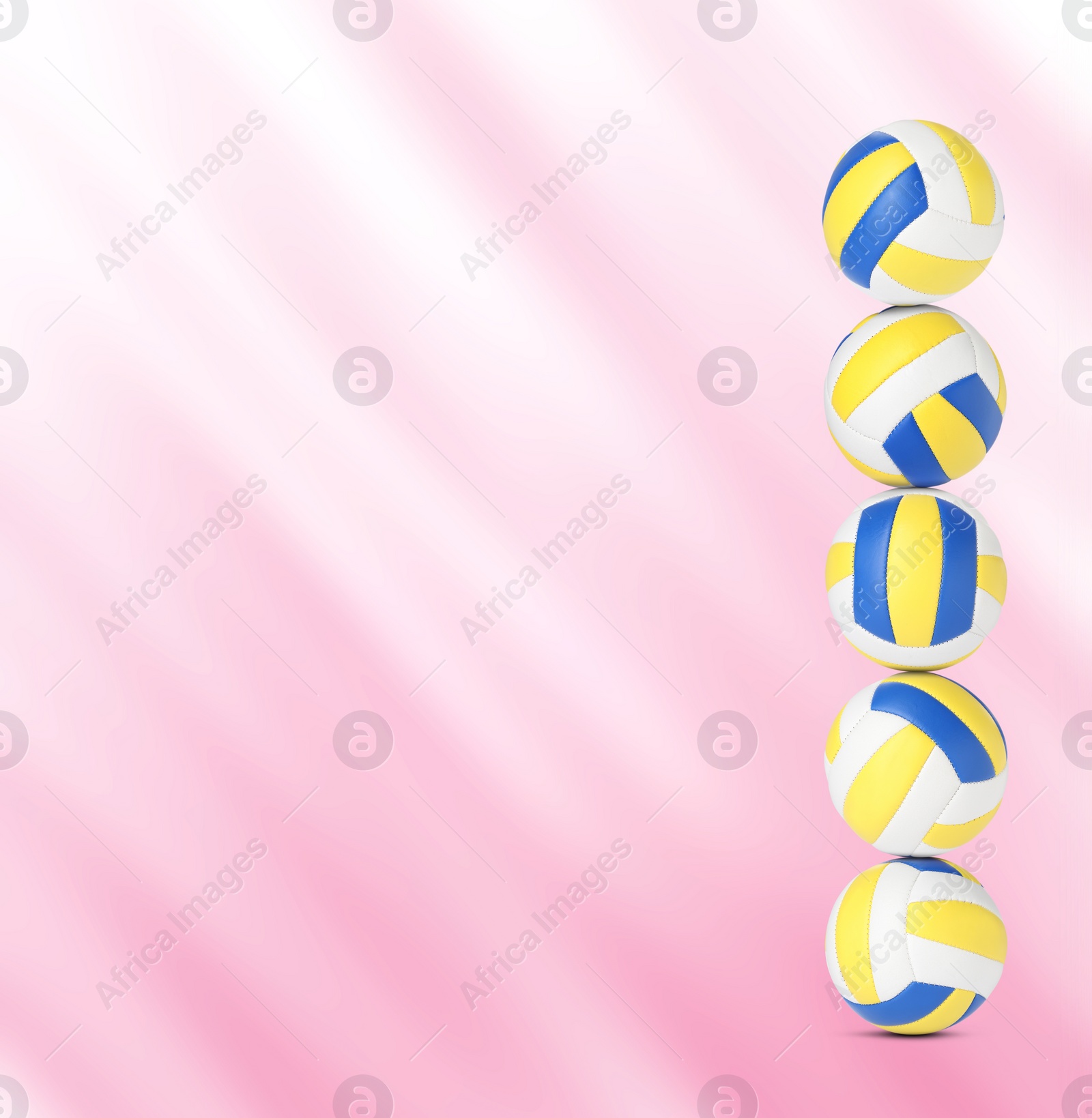 Image of Stack of volleyball balls on pink background, space for text