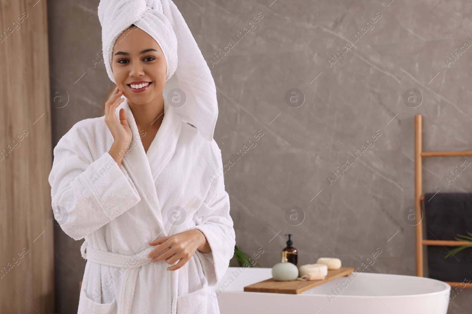 Photo of Beautiful African American woman in bathroom, space for text