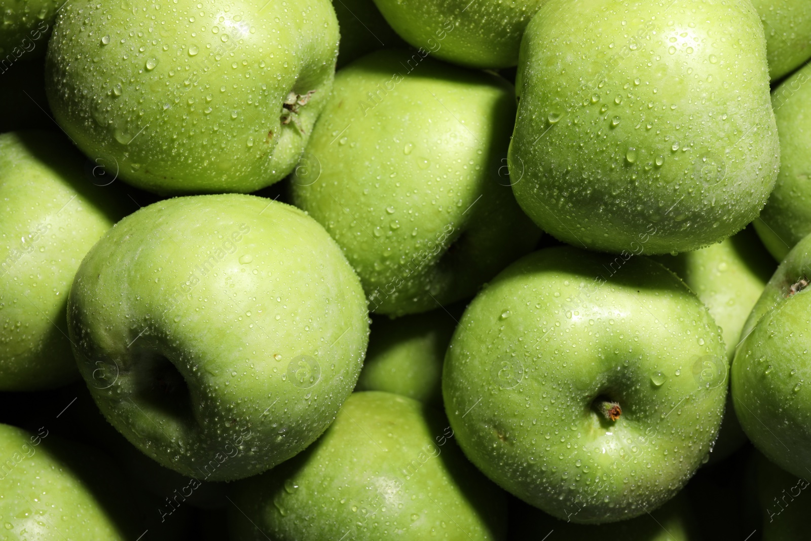 Photo of Fresh green apples with water drops as background, top view