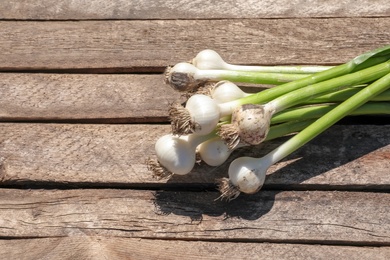 Photo of Fresh garlic bulbs on wooden background, top view