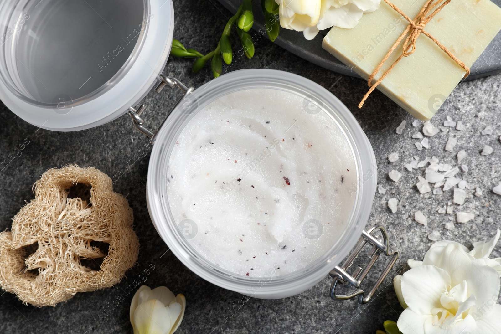 Photo of Flat lay composition with body scrub on grey table