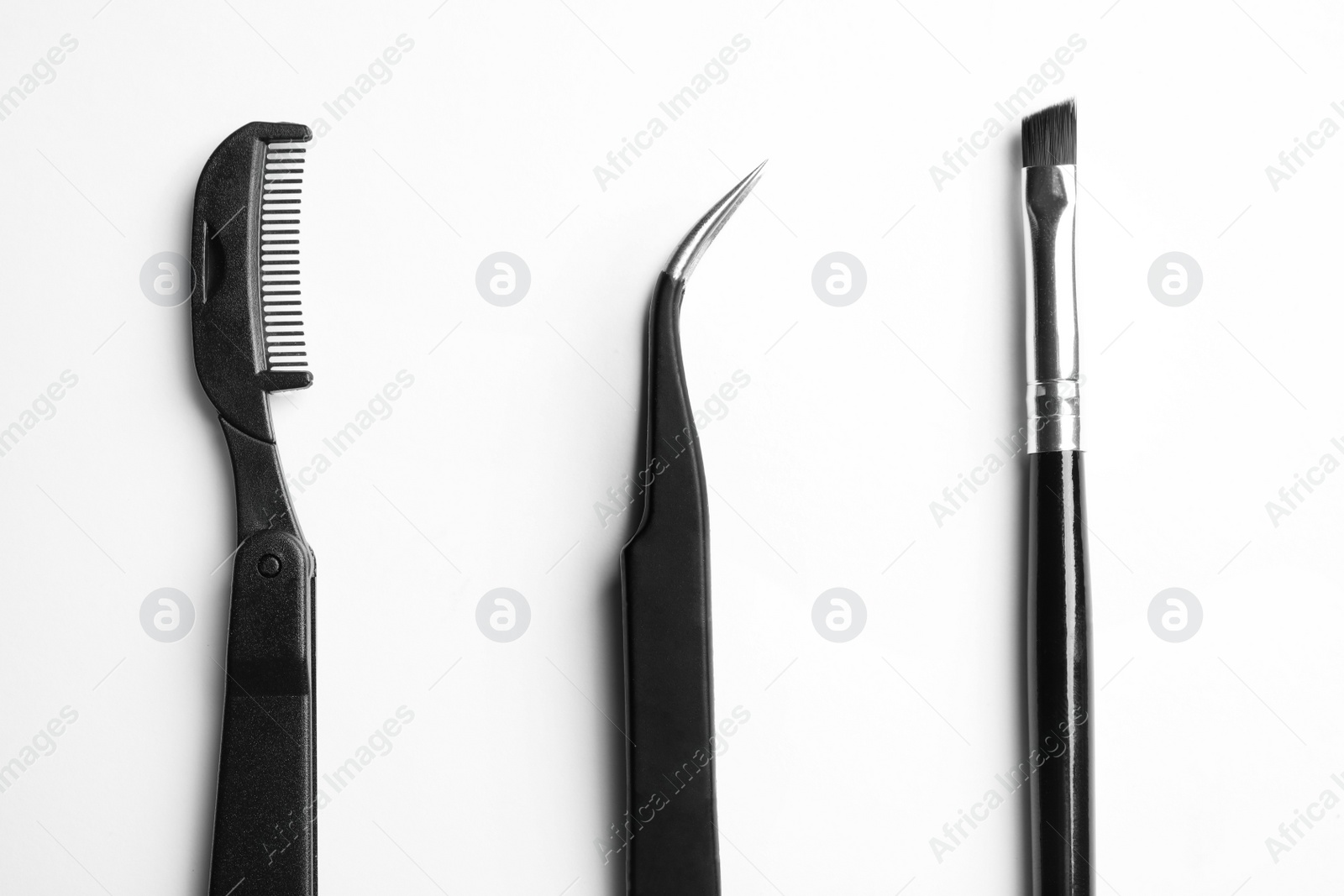 Photo of Set of professional eyebrow tools on white background, top view