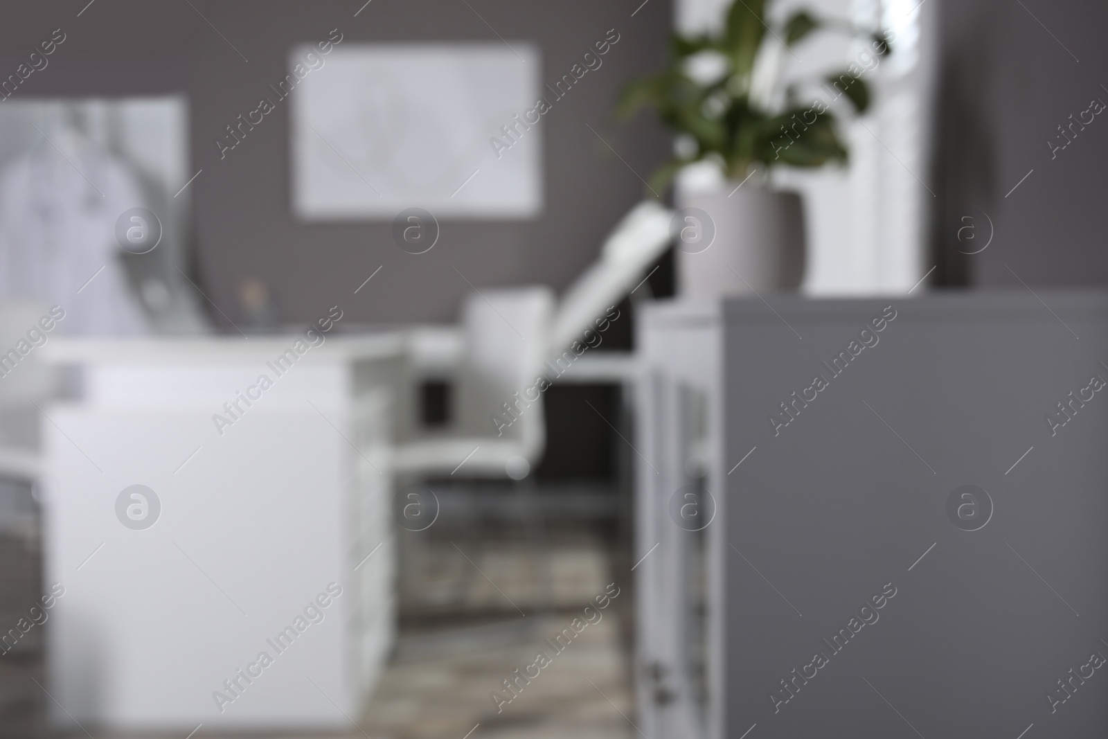 Photo of Blurred view of modern medical office with doctor's workplace. Interior design