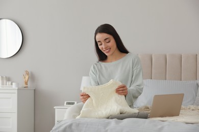 Photo of Young woman choosing clothes for work day at home. Morning routine