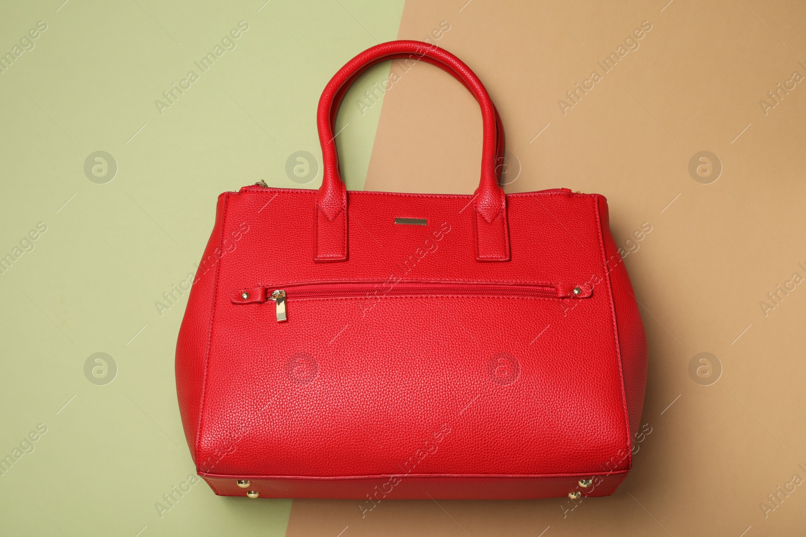 Photo of Stylish women's bag on color background, top view