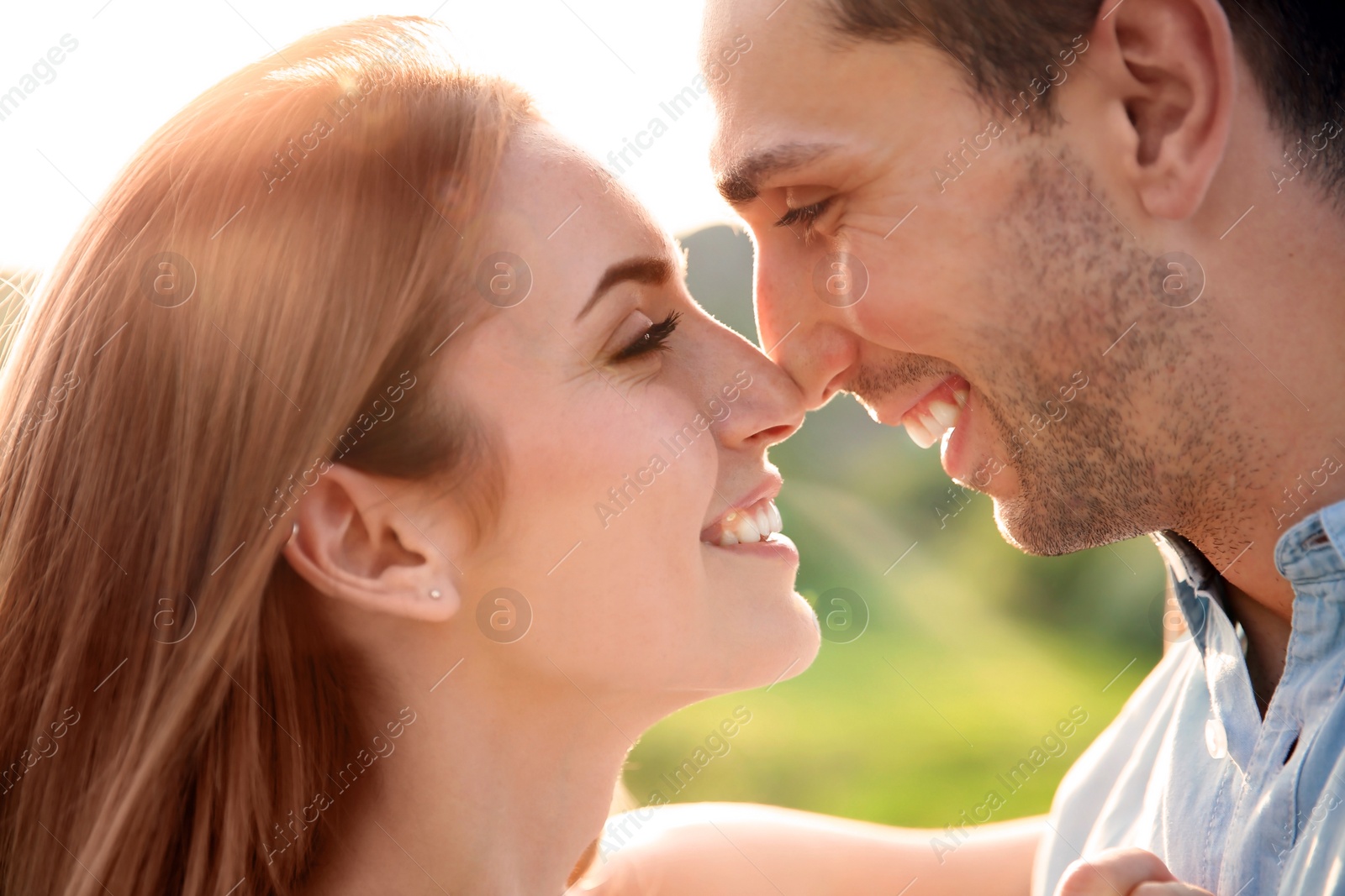 Photo of Cute young couple in love posing outdoors on sunny day