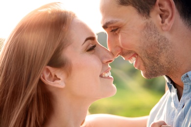 Photo of Cute young couple in love posing outdoors on sunny day