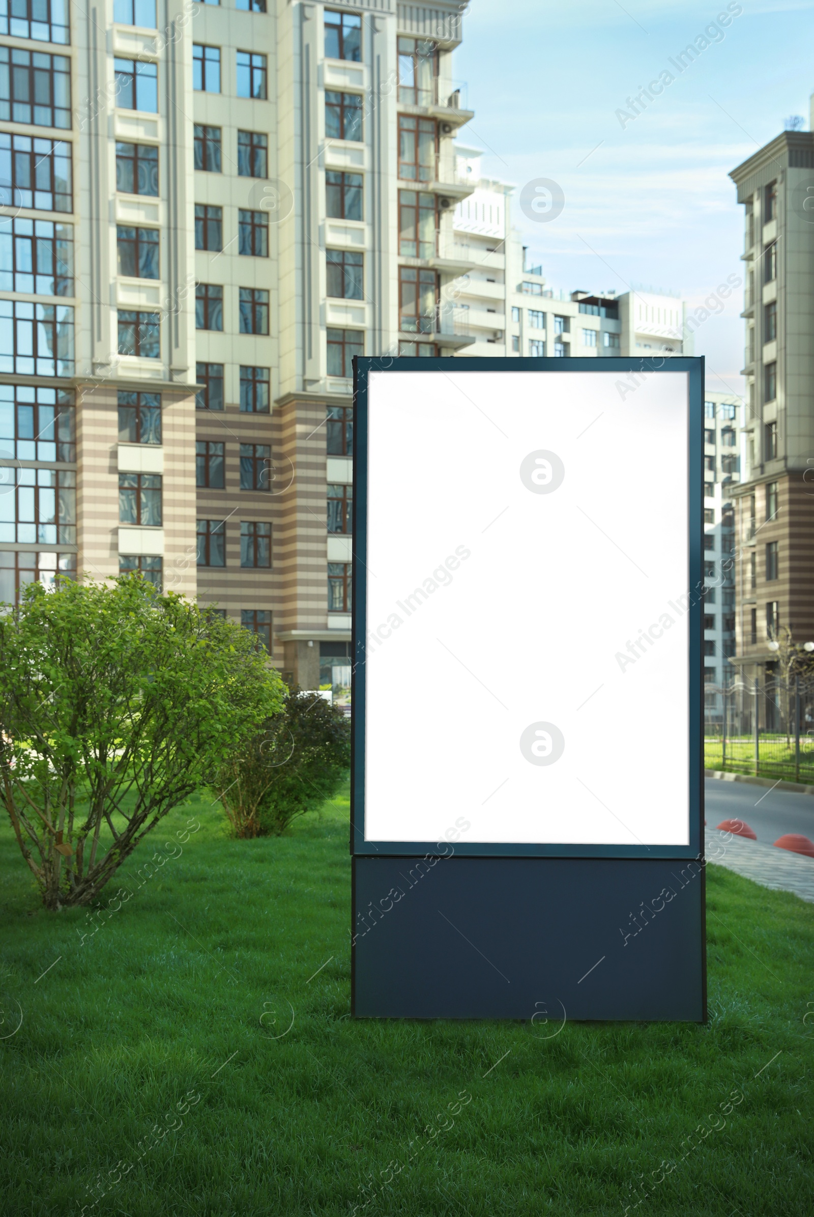 Photo of Blank advertising board on city street. Mockup for design