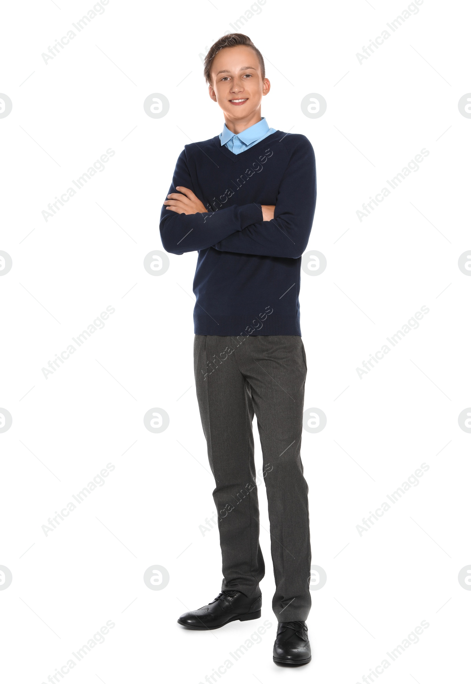 Photo of Teenage boy in stylish school uniform on white background