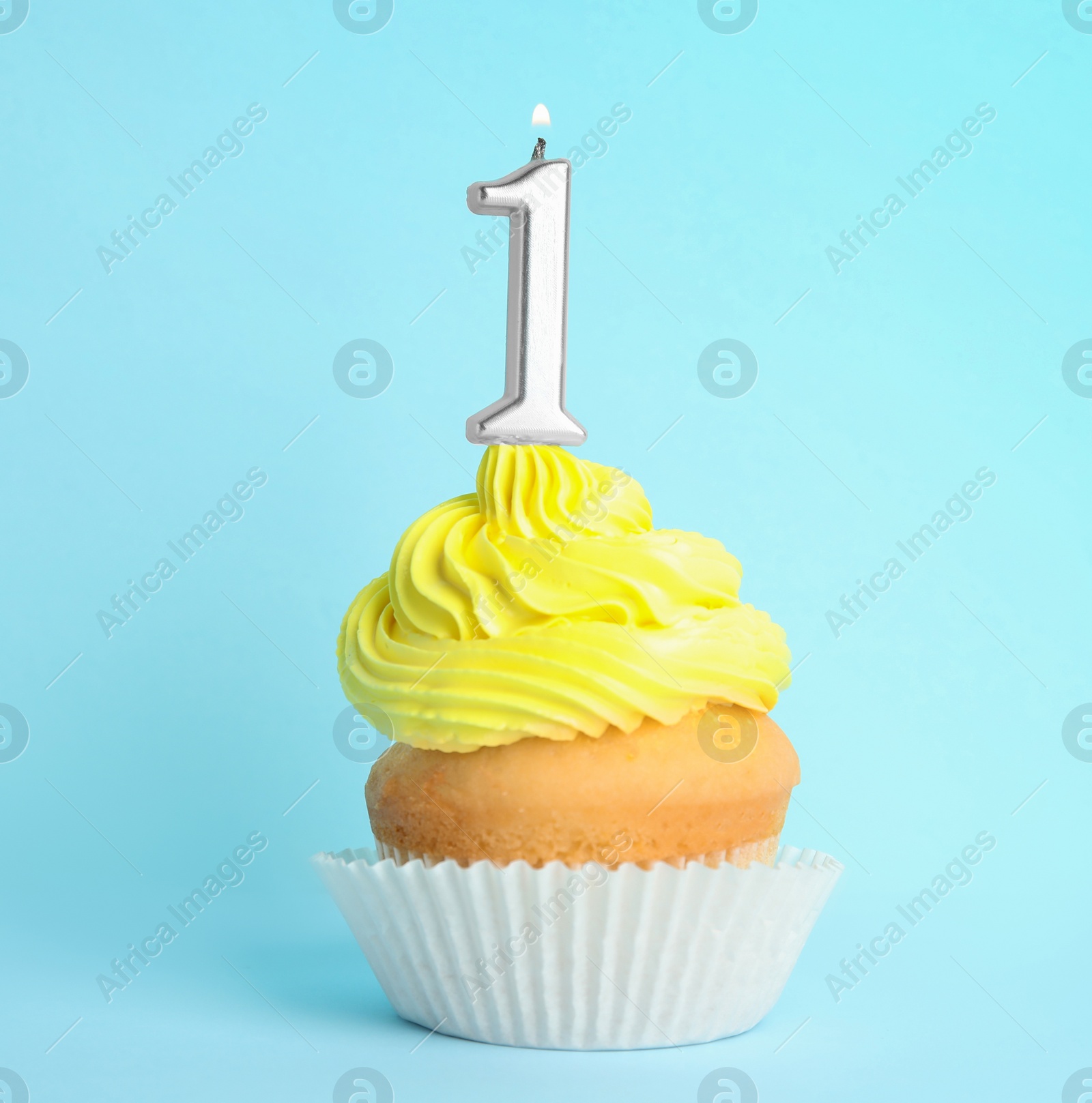 Photo of Birthday cupcake with number one candle on blue background