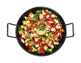 Stir-fry. Tasty noodles with meat and vegetables in wok isolated on white, top view