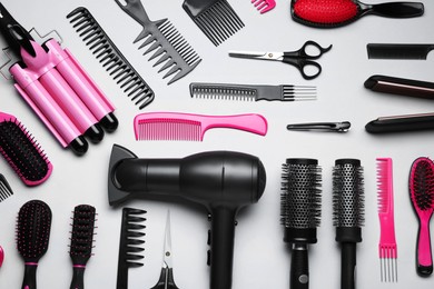 Photo of Flat lay composition of different professional hairdresser tools on white background