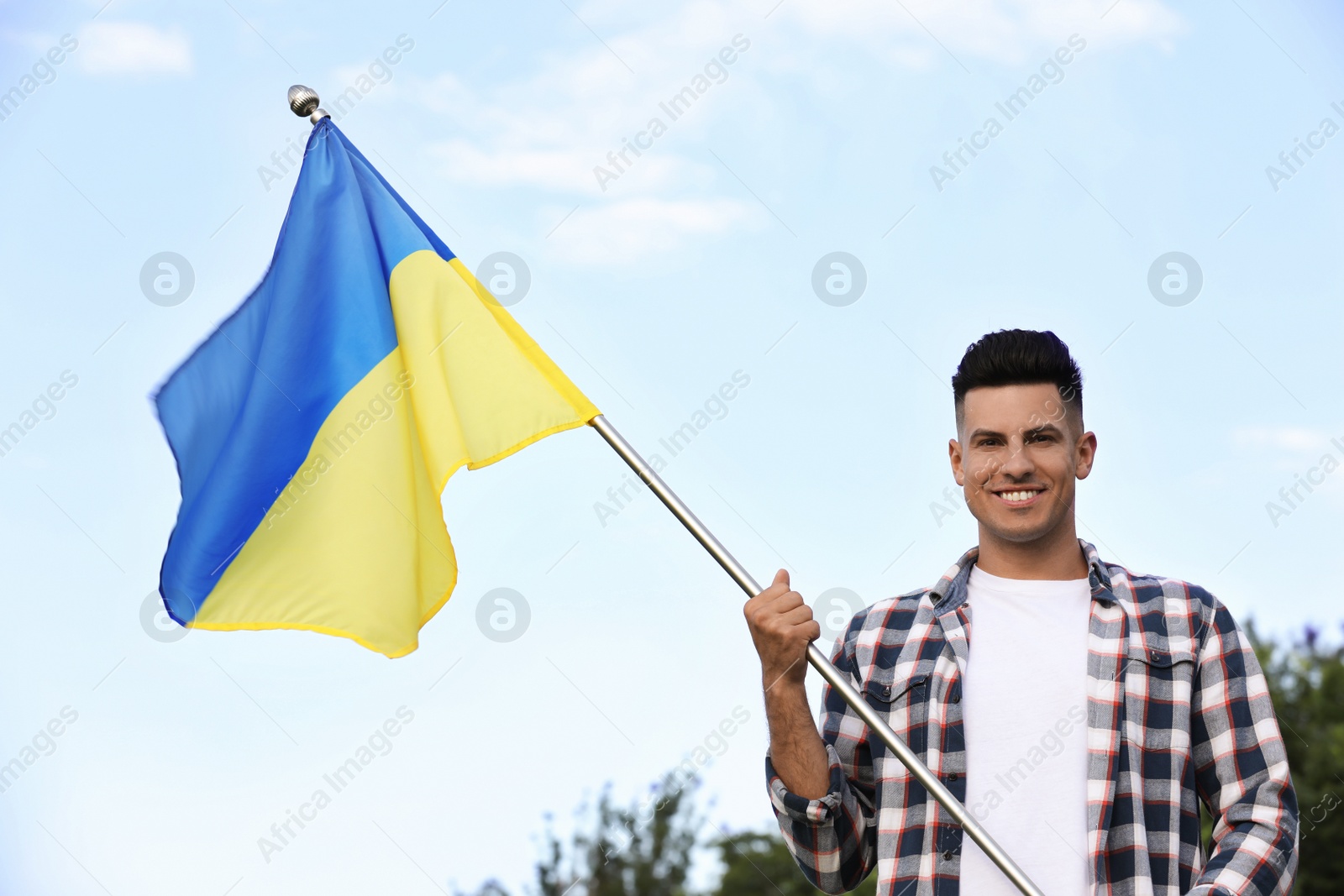 Photo of Man with national flag of Ukraine outdoors