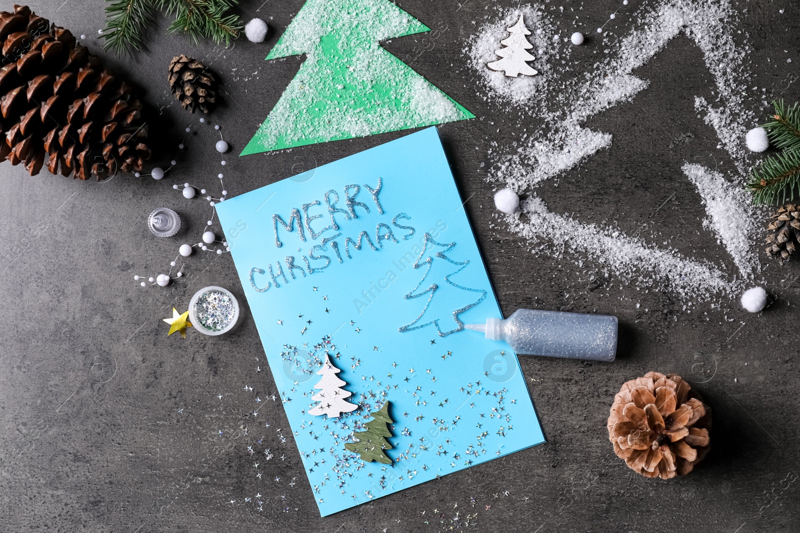 Photo of Beautiful Christmas card and decor on black table, flat lay