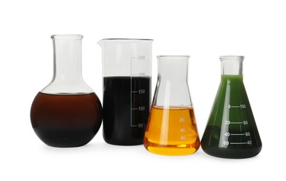 Photo of Laboratory glassware with different types of crude oil isolated on white