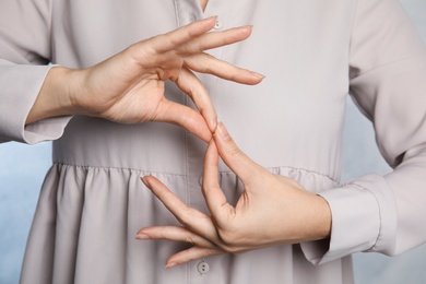 Photo of Woman showing word interpreter, closeup. Sign language