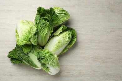 Photo of Fresh ripe Chinese cabbages on white wooden table, flat lay. Space for text