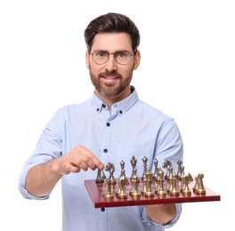 Handsome man holding chessboard with game pieces on white background