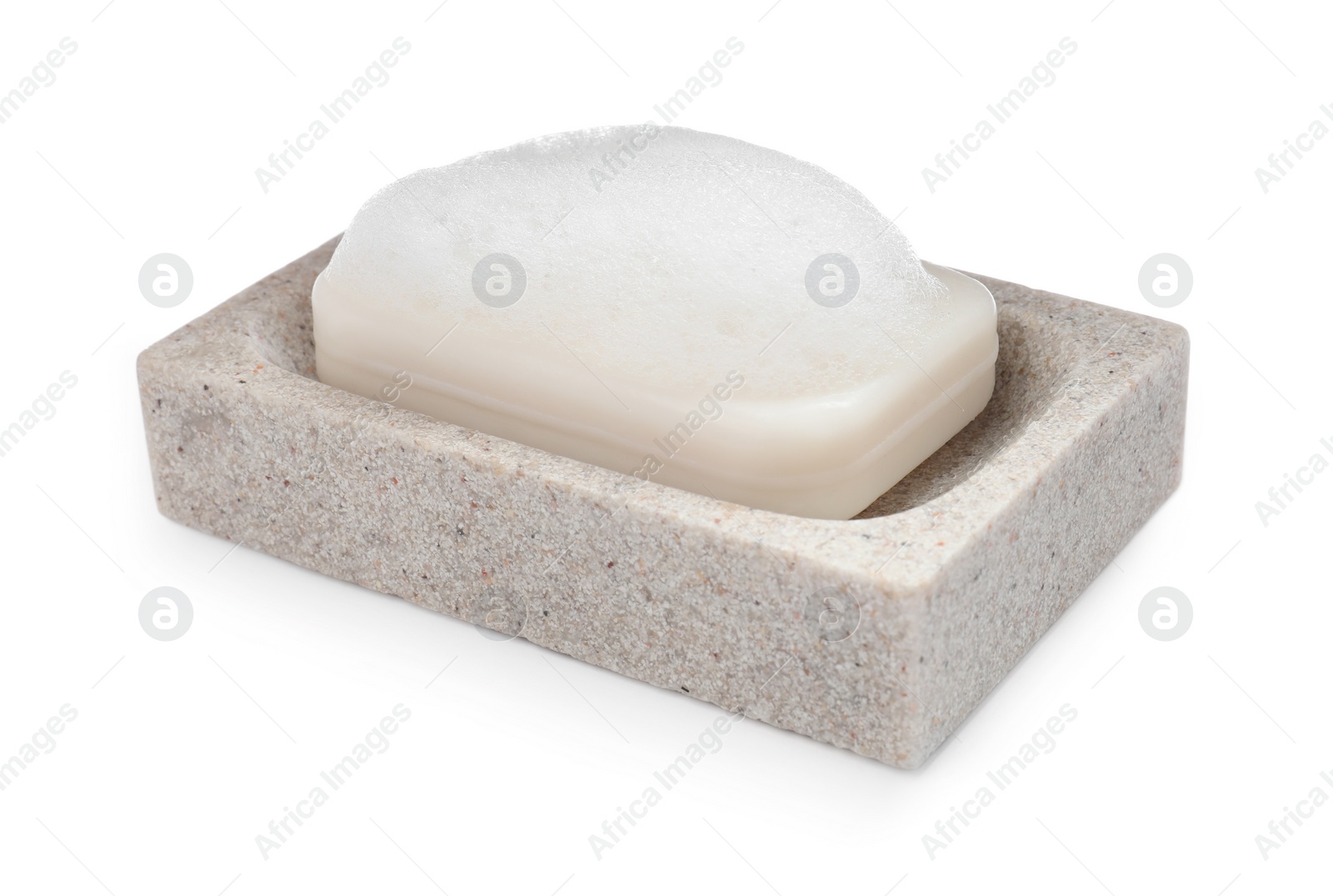 Photo of Soap bar with fluffy foam in holder on white background