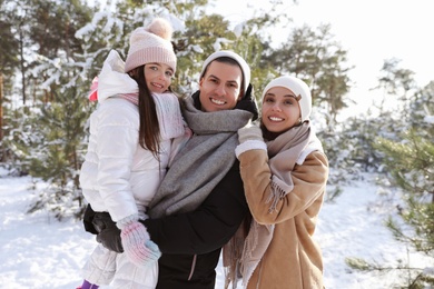 Happy family outdoors on winter day. Christmas vacation
