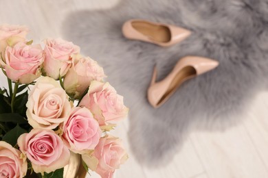 Photo of Beautiful bouquet of rose flowers and stylish shoes indoors, top view with space for text. Happy birthday
