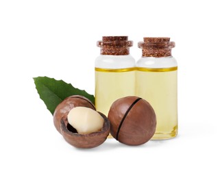 Photo of Delicious organic Macadamia nuts, natural oil and green leaf isolated on white