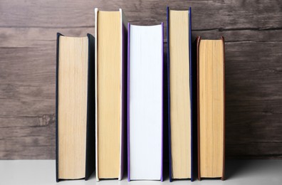 Collection of different books on white shelf