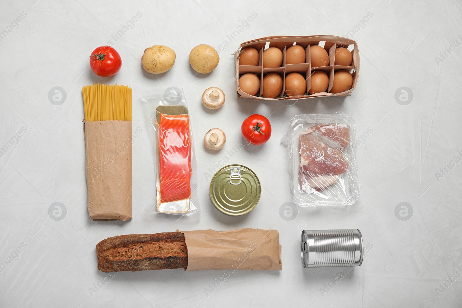 Photo of Fresh vegetables and other products on light grey background, flat lay