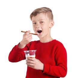 Little boy with yogurt on white background