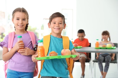 Children with healthy food at school canteen