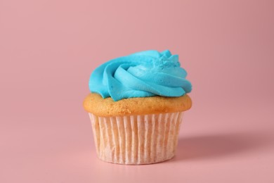 Photo of Delicious cupcake with bright cream on pink background