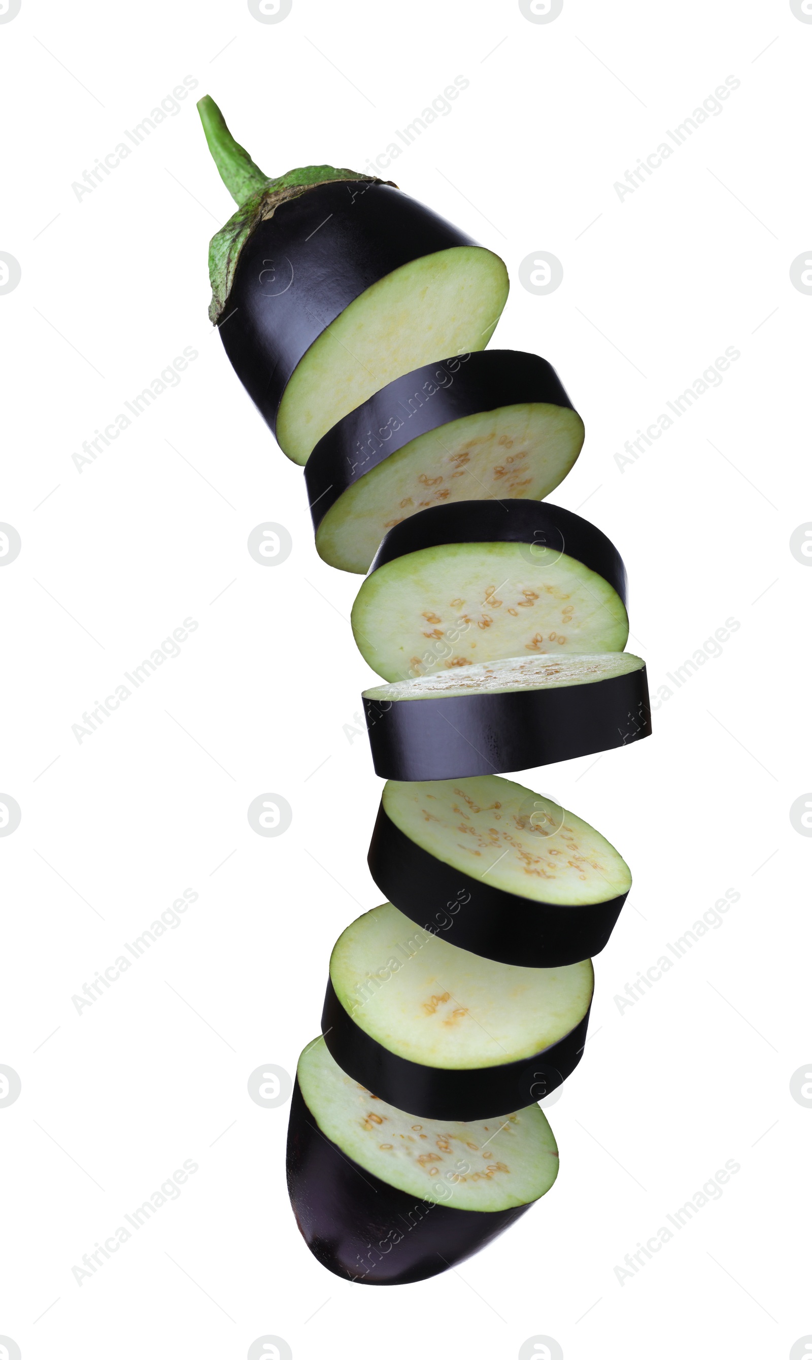 Image of Cut fresh eggplant pieces falling on white background