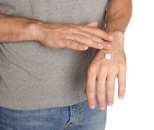 Photo of Man applying cream onto hand on white background, closeup