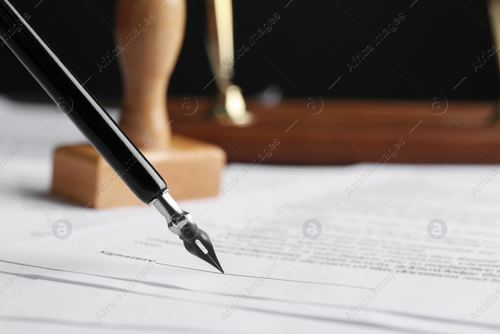 Photo of Signing notary document with fountain pen, closeup