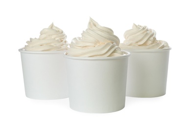 Photo of Cups with tasty frozen yogurt on white background