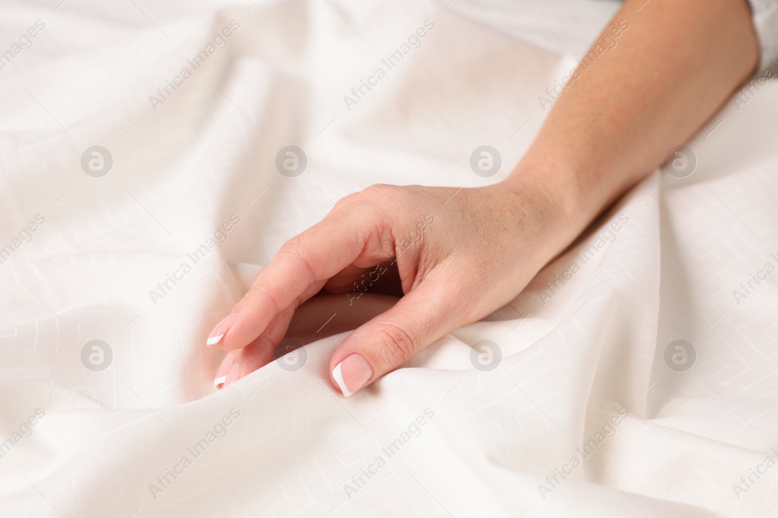 Photo of Woman touching smooth silky fabric, closeup view