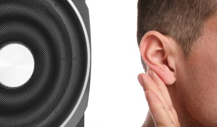 Modern audio speaker and man on white background, closeup view of ear