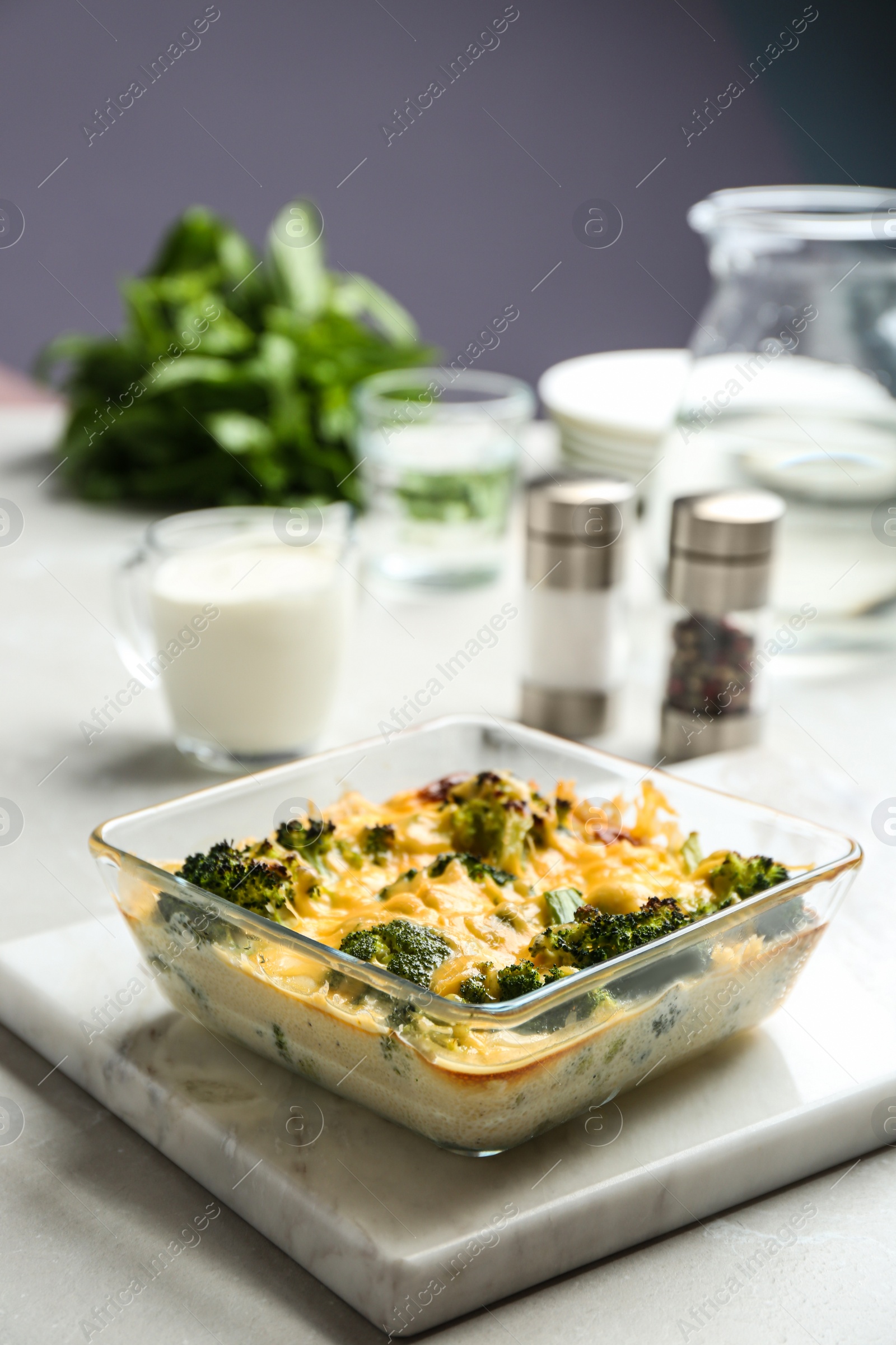 Photo of Tasty broccoli casserole in baking dish on table