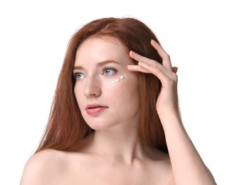 Photo of Beautiful woman with freckles and cream on her face against white background