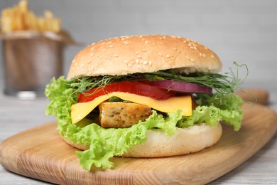 Delicious burger with tofu and fresh vegetables on table, closeup